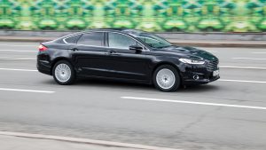Ford Mondeo MK5 goes fast on the asphalt road. Fourth-generation Ford Mondeo in city street